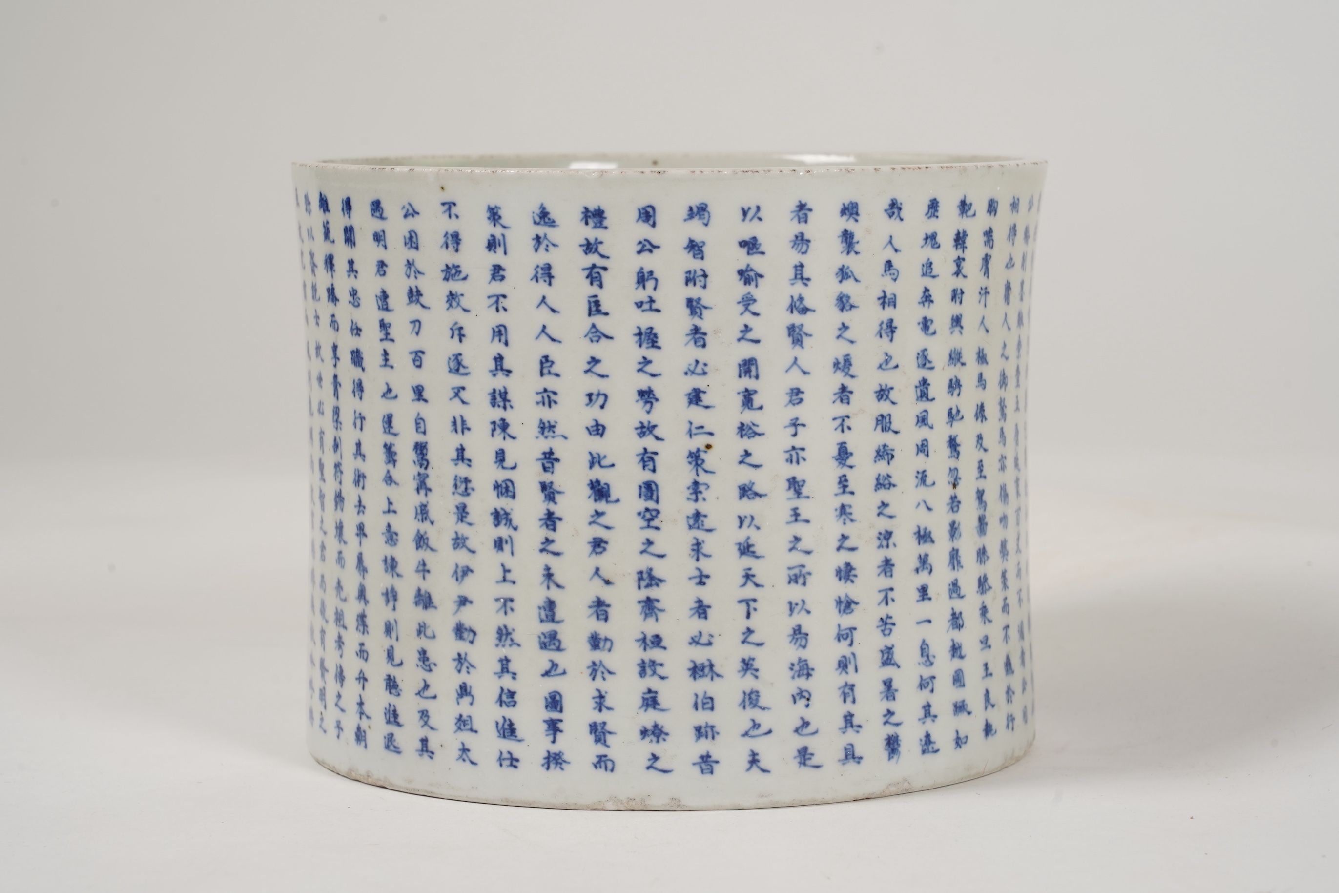 A Chinese underglaze blue and copper red inscribed brush pot, possibly Kangxi period
